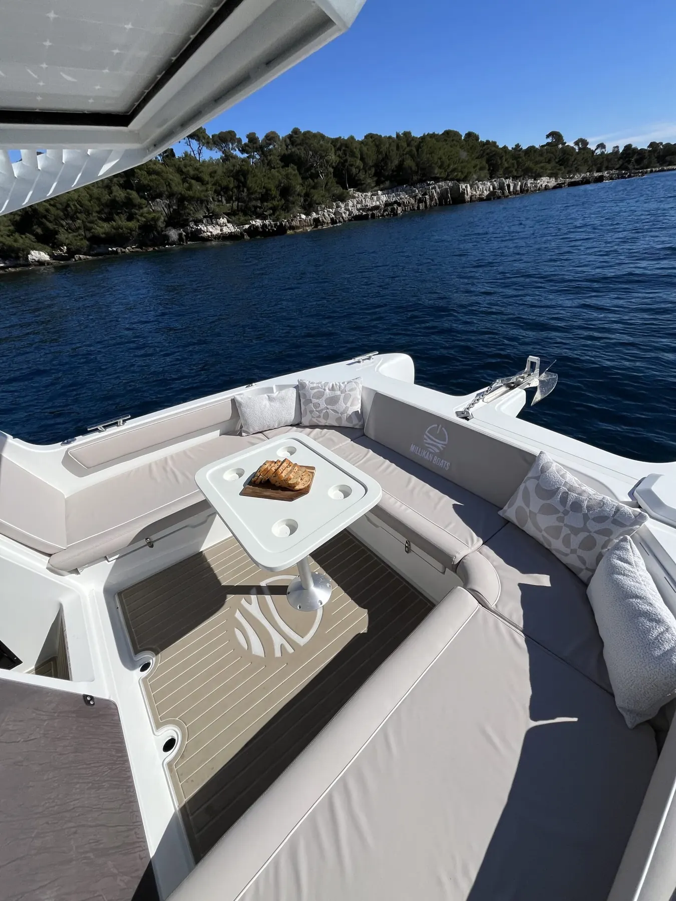 Forward lounge seen from the saloon, cushions and table, sea ahead